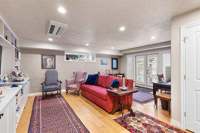Example of a mid-sized classic laminate floor and yellow floor basement design in Seattle