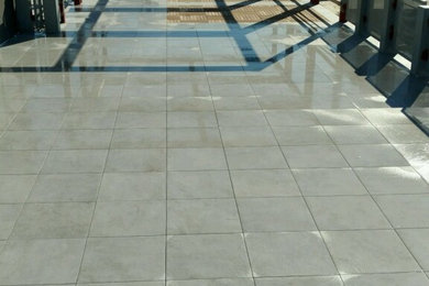 Large trendy rooftop deck photo in Orange County with a pergola