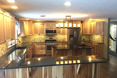 Inspiration for a large rustic l-shaped dark wood floor eat-in kitchen remodel in Other with a double-bowl sink, flat-panel cabinets, light wood cabinets, granite countertops, brown backsplash, stone tile backsplash, stainless steel appliances and an island