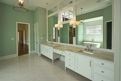 This is an example of a mid-sized master bathroom in Other with recessed-panel cabinets, white cabinets, a freestanding tub, an alcove shower, gray tile, stone tile, green walls, marble floors, an undermount sink, engineered quartz benchtops, white floor and a hinged shower door.