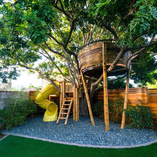 Modelo de jardín contemporáneo, grande, en patio trasero, con parque infantil y gravilla