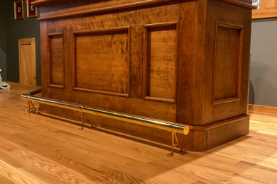 Home bar - traditional light wood floor home bar idea in Other with raised-panel cabinets, medium tone wood cabinets and wood countertops