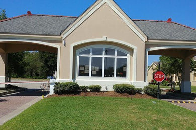 Small elegant beige one-story gable roof photo in Charlotte with a shingle roof