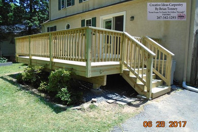 Inspiration for a mid-sized timeless backyard wood railing deck remodel in Philadelphia with no cover