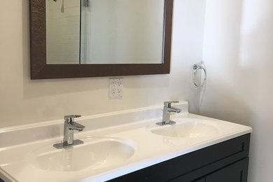 Example of a mid-sized trendy master white tile bathroom design in Los Angeles with furniture-like cabinets and brown cabinets