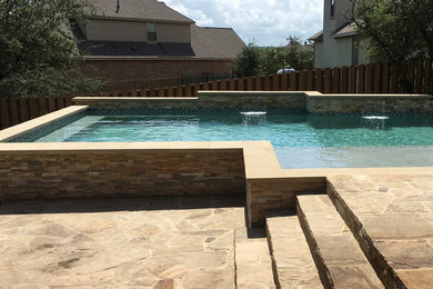 Example of a large classic backyard tile and custom-shaped hot tub design in Austin