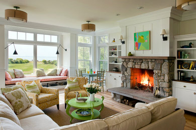 Mid-sized beach style formal and open concept light wood floor and brown floor living room photo in Boston with beige walls, a standard fireplace, a stone fireplace and no tv