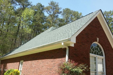 Inspiration for a mid-sized timeless red one-story brick gable roof remodel in Atlanta