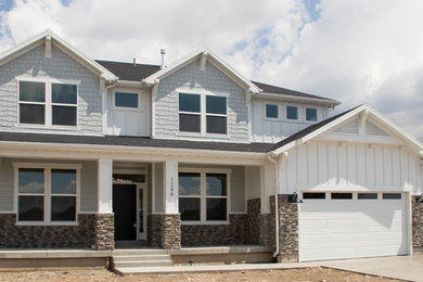 Large blue two-story concrete fiberboard house exterior idea in Salt Lake City with a shingle roof