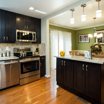 Espresso Kitchen Remodel with Granite Island and Stainless Steel Appliances