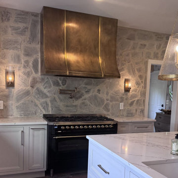 Aged Brass Range Hood — Farmhouse Kitchen with Stone Wall