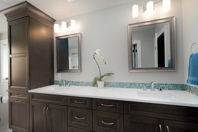 Example of a transitional blue tile and glass sheet beige floor and double-sink drop-in bathtub design in Seattle with recessed-panel cabinets, gray cabinets, a one-piece toilet, an undermount sink, quartz countertops, a hinged shower door, white countertops and a built-in vanity