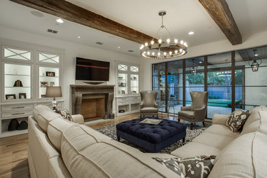 Inspiration for a large transitional open concept light wood floor living room remodel in Dallas with white walls, a standard fireplace and a wall-mounted tv