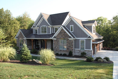 Large mountain style gray two-story mixed siding exterior home photo in Other with a tile roof