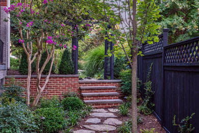 Design ideas for a mid-sized traditional partial sun backyard stone landscaping in DC Metro for summer.
