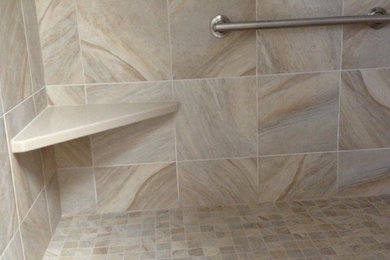 Example of a mid-sized transitional marble tile alcove shower design in Other