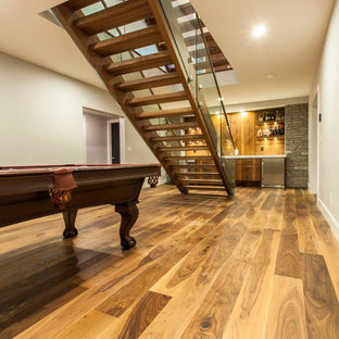 Design ideas for a contemporary fully buried basement in Edmonton with white walls and medium hardwood flooring.