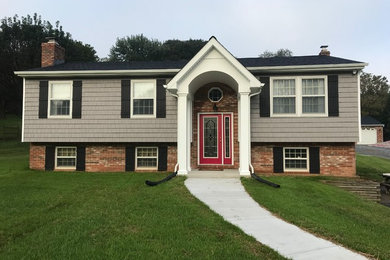Mid-sized front porch idea in Baltimore with a roof extension