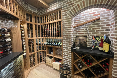 Mid-sized mountain style light wood floor wine cellar photo in Jacksonville