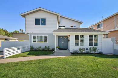 Inspiration for a large coastal white two-story wood exterior home remodel in Los Angeles with a shingle roof