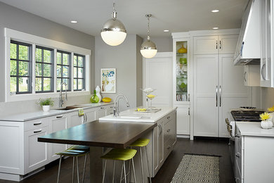 Inspiration for a large contemporary u-shaped dark wood floor open concept kitchen remodel in Grand Rapids with an undermount sink, shaker cabinets, white cabinets, wood countertops, white backsplash, paneled appliances and an island