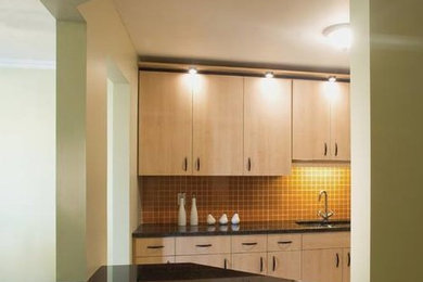 Small galley light wood floor eat-in kitchen photo in Ottawa with an undermount sink, flat-panel cabinets, light wood cabinets, orange backsplash, ceramic backsplash and an island