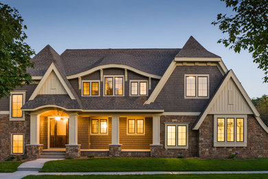 Example of a large classic gray two-story mixed siding exterior home design in Minneapolis with a clipped gable roof
