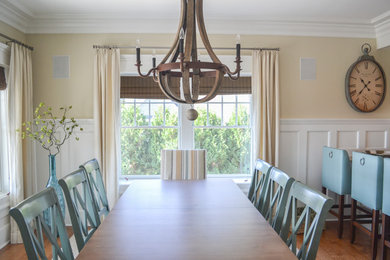 Example of a large transitional medium tone wood floor and brown floor enclosed dining room design in Bridgeport with yellow walls and no fireplace