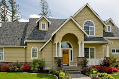 Inspiration for a mid-sized transitional beige two-story vinyl exterior home remodel in Other with a shingle roof