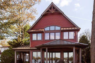 Design ideas for a mid-sized transitional two-storey red house exterior in Detroit with concrete fiberboard siding and a metal roof.