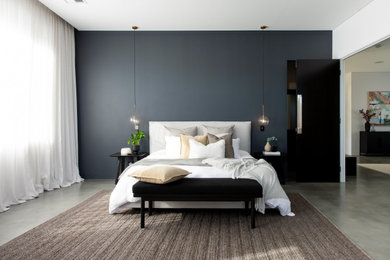 Large modern master bedroom in Other with grey walls, concrete floors and grey floor.