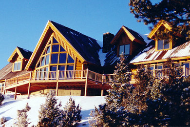 Inspiration for a large craftsman brown wood exterior home remodel in Other with a shed roof