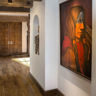 This is an example of a large country foyer in Phoenix with white walls, medium hardwood floors, a double front door and a medium wood front door.