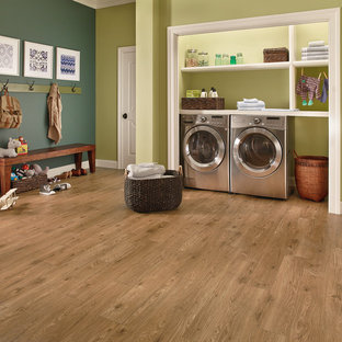 Design ideas for a medium sized classic single-wall utility room in Other with open cabinets, white cabinets, wood worktops, green walls, light hardwood flooring, a side by side washer and dryer and green floors.