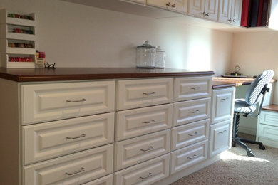 Inspiration for a large contemporary built-in desk carpeted craft room remodel in Salt Lake City with beige walls