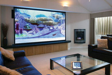 Photo of a large open concept home theatre in Sydney with beige walls, carpet and a projector screen.