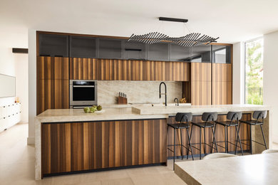 Inspiration for a large contemporary ceramic tile and beige floor open concept kitchen remodel in New York with an undermount sink, flat-panel cabinets, dark wood cabinets, quartz countertops, beige backsplash, quartz backsplash, paneled appliances, an island and beige countertops