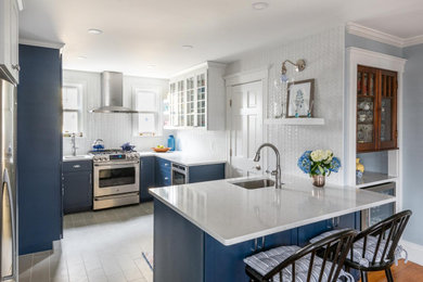 Example of a mid-sized transitional u-shaped porcelain tile and gray floor eat-in kitchen design in Boston with an undermount sink, shaker cabinets, blue cabinets, quartz countertops, white backsplash, subway tile backsplash, stainless steel appliances, a peninsula and white countertops