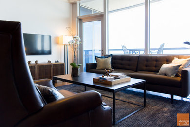 Example of a mid-sized 1960s open concept medium tone wood floor living room design in Chicago with a bar, beige walls, no fireplace and a wall-mounted tv