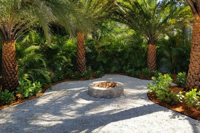 Design ideas for a tropical partial sun gravel landscaping in Other with a fire pit.
