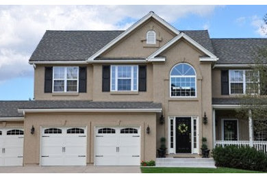 Example of a classic beige two-story mixed siding exterior home design in Austin