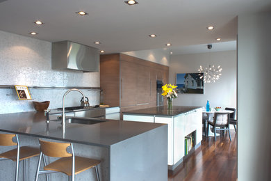 Inspiration for a large modern l-shaped dark wood floor and brown floor open concept kitchen remodel in Boston with an undermount sink, flat-panel cabinets, medium tone wood cabinets, quartz countertops, multicolored backsplash, mosaic tile backsplash, paneled appliances and an island