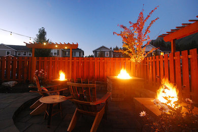 Inspiration for a large contemporary backyard patio in Seattle with a fire feature, concrete pavers and no cover.