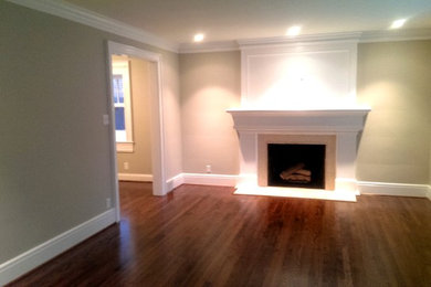 Inspiration for a contemporary formal and enclosed dark wood floor living room remodel in Detroit with beige walls, a standard fireplace, a wood fireplace surround and no tv
