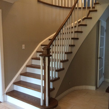 Mississauga hardwood stairs reno with square white spindles - showing view foyer