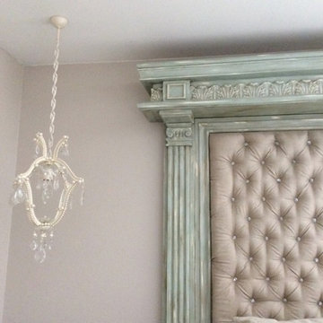 Petit French chandeliers with faux pearls over night tables