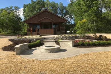 Example of a mid-sized trendy brick patio design in Detroit with a fire pit