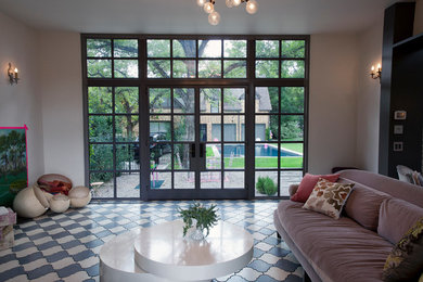 Example of a mid-sized eclectic enclosed marble floor and gray floor living room design in Austin with pink walls, no fireplace and a tv stand