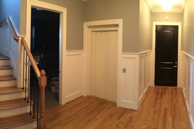 Small minimalist medium tone wood floor hallway photo in Louisville with beige walls