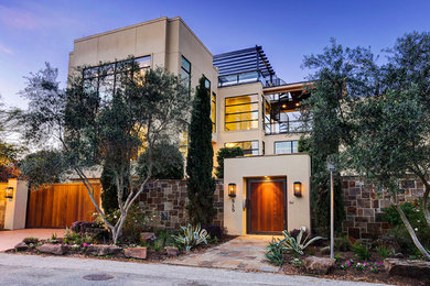 Large contemporary beige three-story stucco exterior home idea in Houston